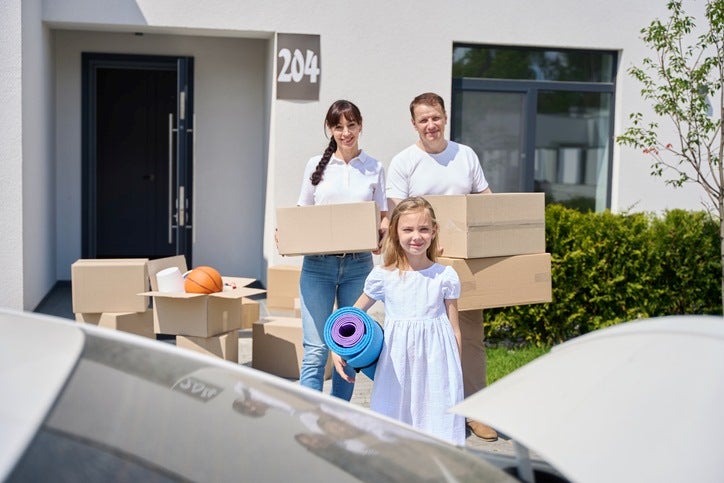 Family packing boxes in front of their house in Capitola, CA